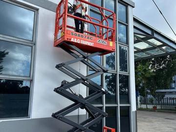 Electric scissor lift raised for M&E ceiling work in Johor Bahru