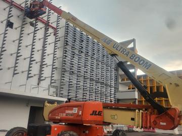 JLG 1250AJP boom lift working on a building facade job in Johor